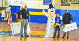Griffin learns he's the winner of the contest during a school assembly.