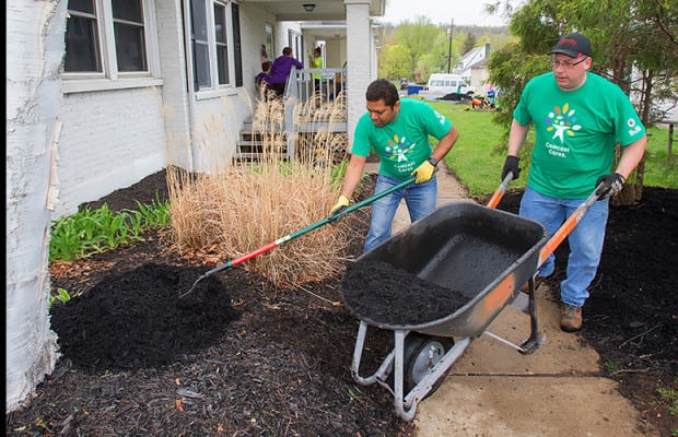 Volunteers in Asbury, N.J. spread mulch at The Arc of Warren County’s community living group home, which supports individuals with disabilities.