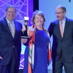 Woman of the Year D'Arcy Rudnay with Comcast CEO Brian Roberts and senior EVP David Cohen. (Photo by Larry Busacca, Getty Images)