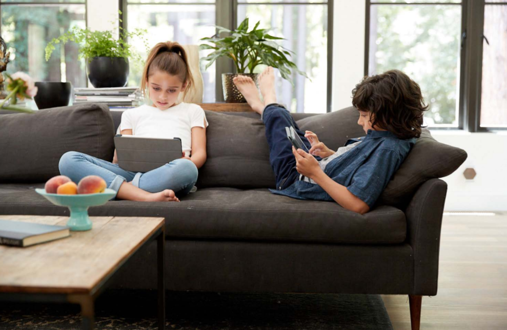 Two children with tablets in hand